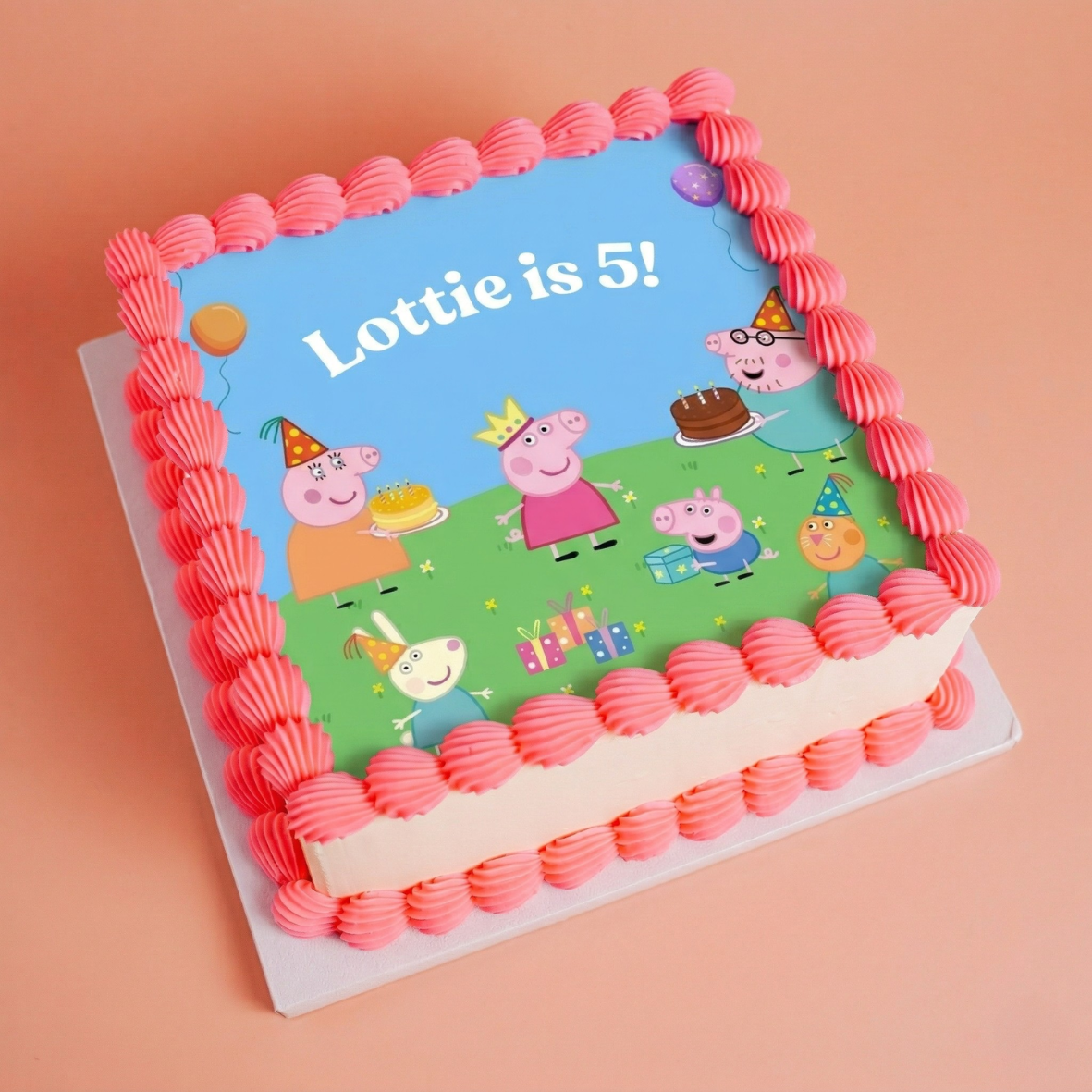 SQUARE kids birthday Birthday cake with Peppa Pig design and pink border on a peach background