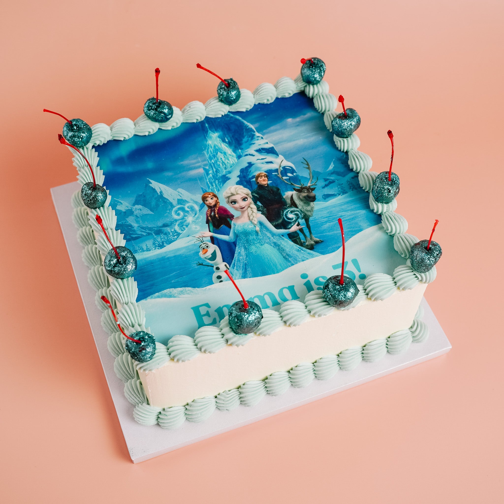 Frozen-themed birthday cake with characters and &