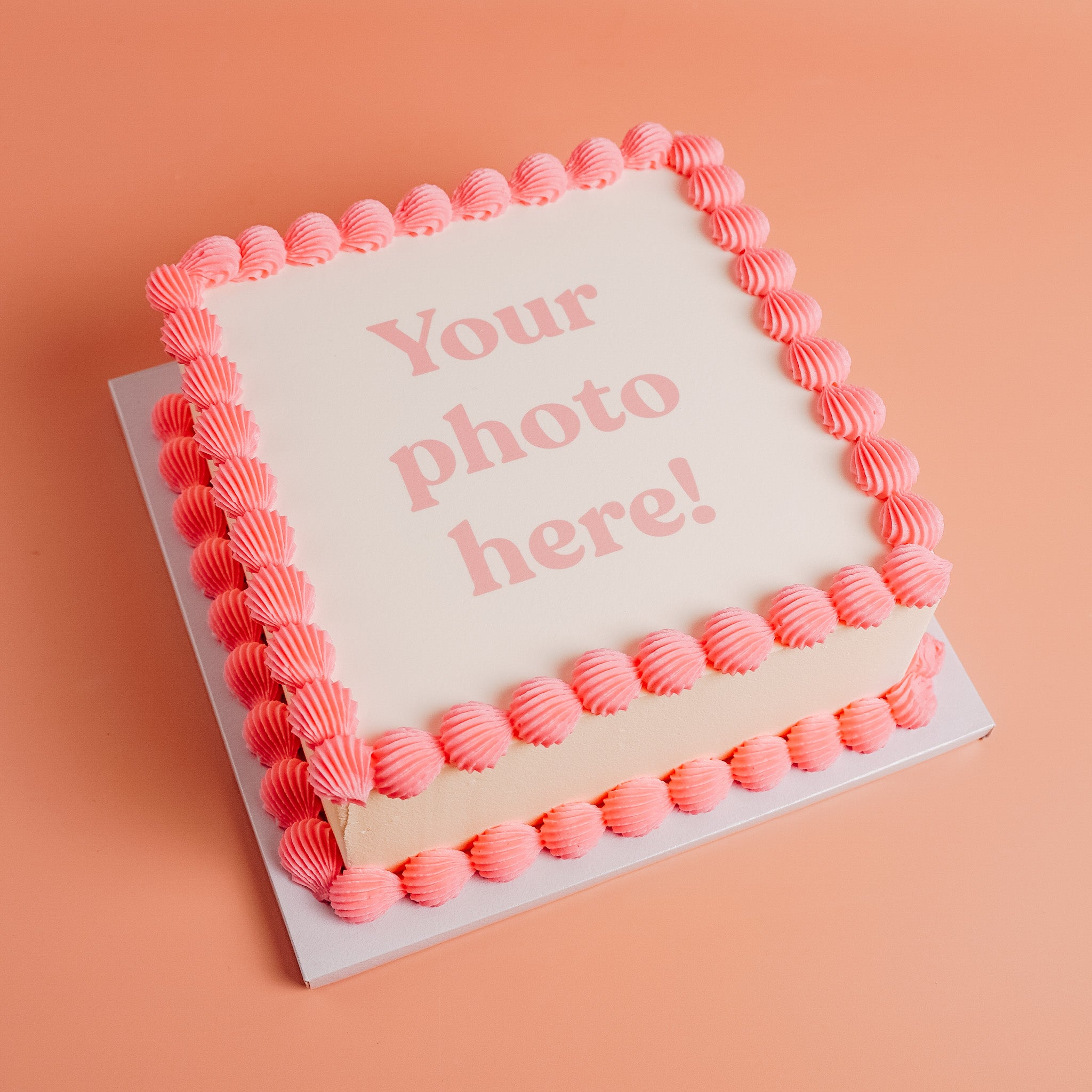 white square showing that a customer can upload their own photo to be printed on the top of the cake and framed with pink buttercream border.