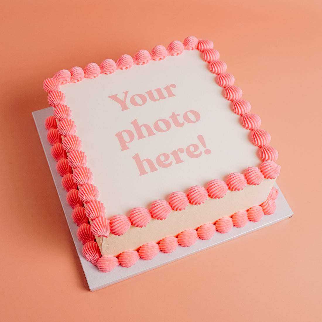 white square showing that a customer can upload their own photo to be printed on the top of the cake and framed with pink buttercream border.