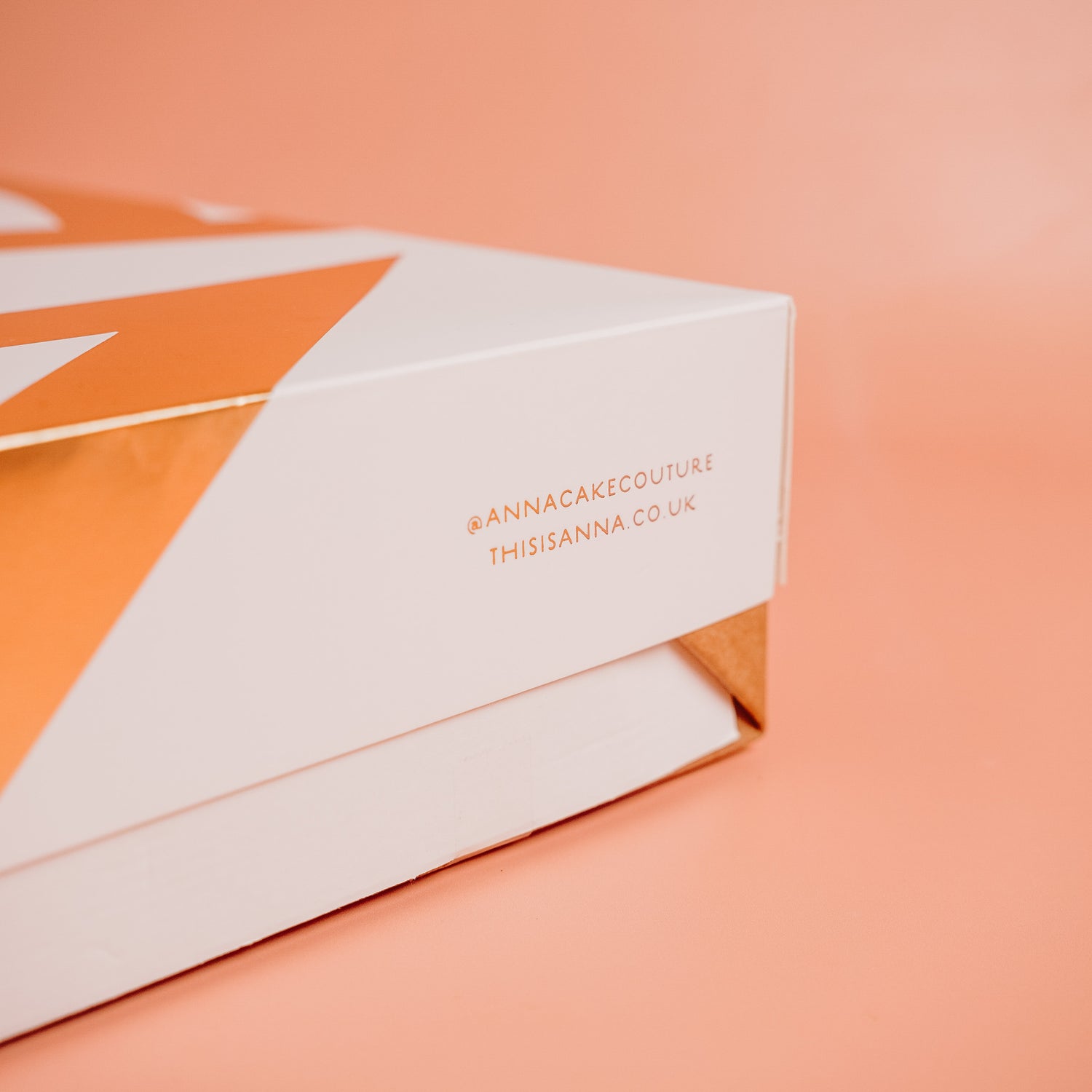 White box with orange accents and &