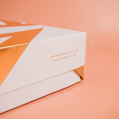 White box with orange accents and &